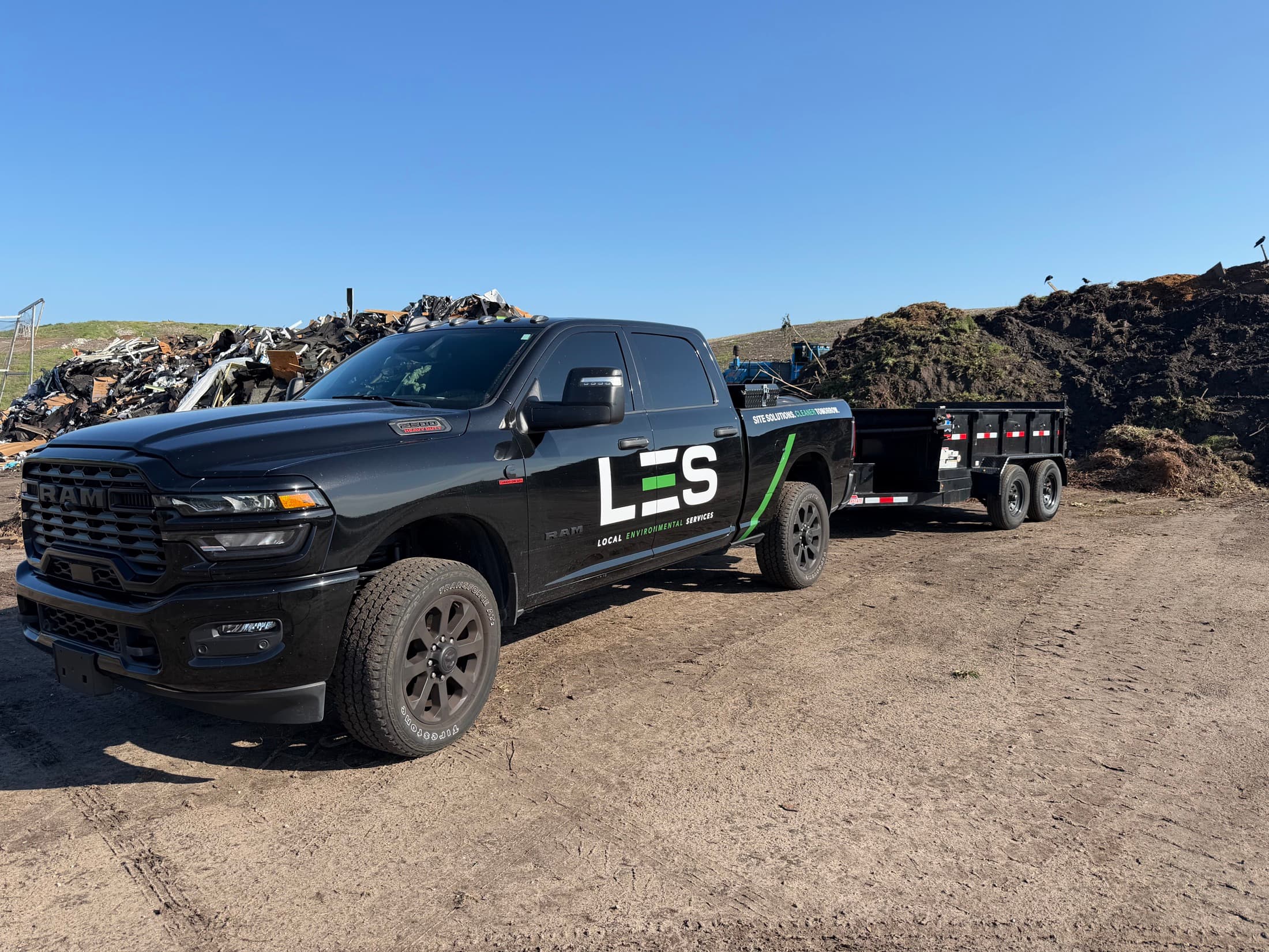 LES branded truck and dump trailer on a Central Florida site